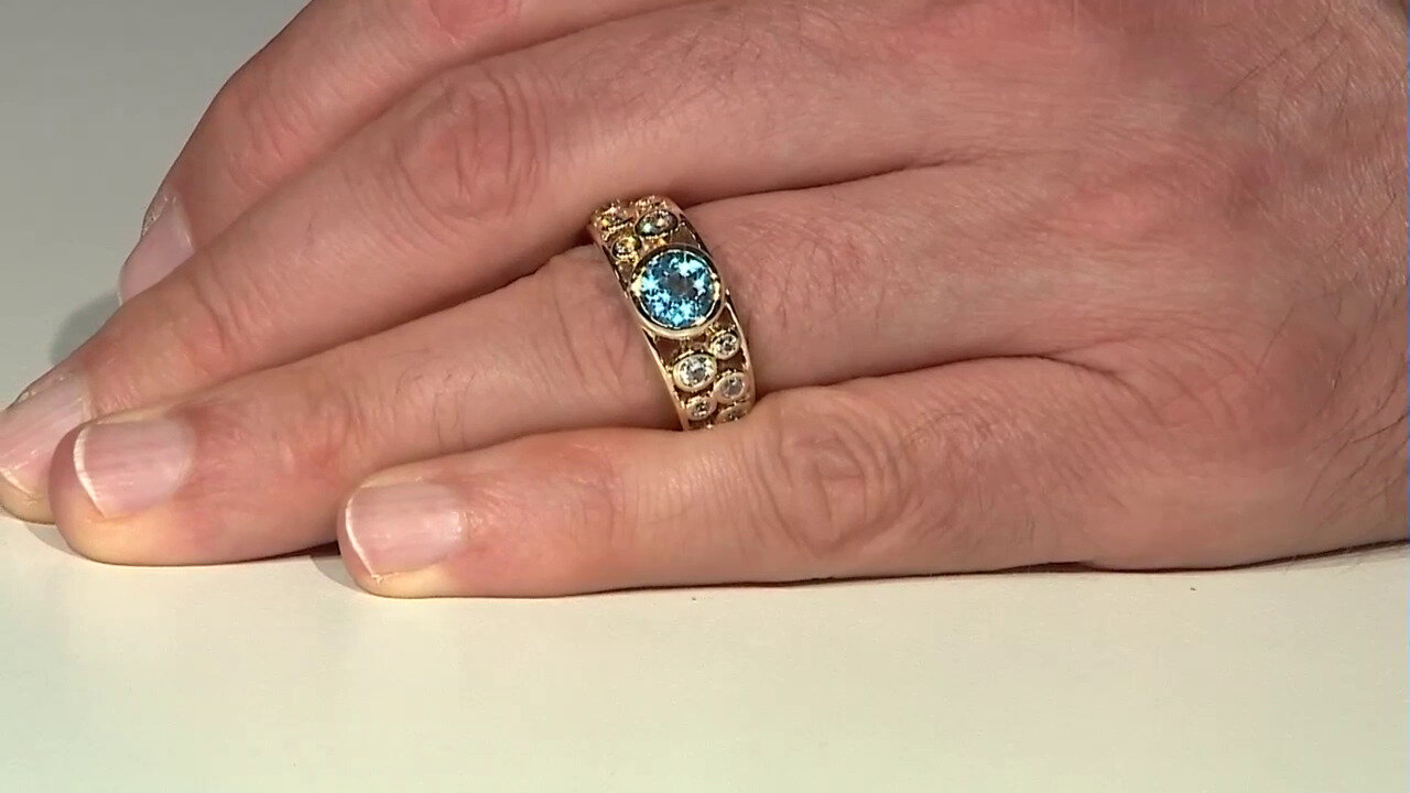Video Gouden ring met een Zwitsers-blauwe topaas (de Melo)